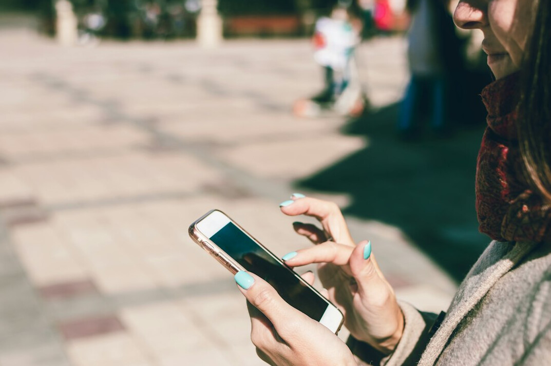 people scrolling on smartphones in public